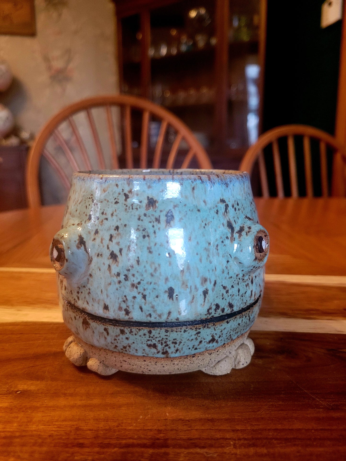 Blue ceramic mug with decorative design on a wooden table