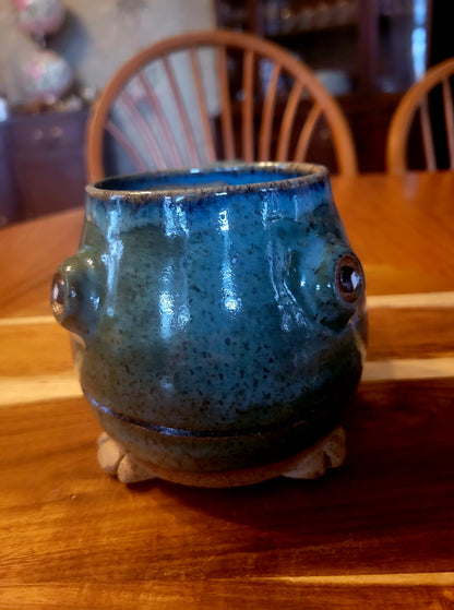 Blue ceramic mug with a textured surface on a wooden table