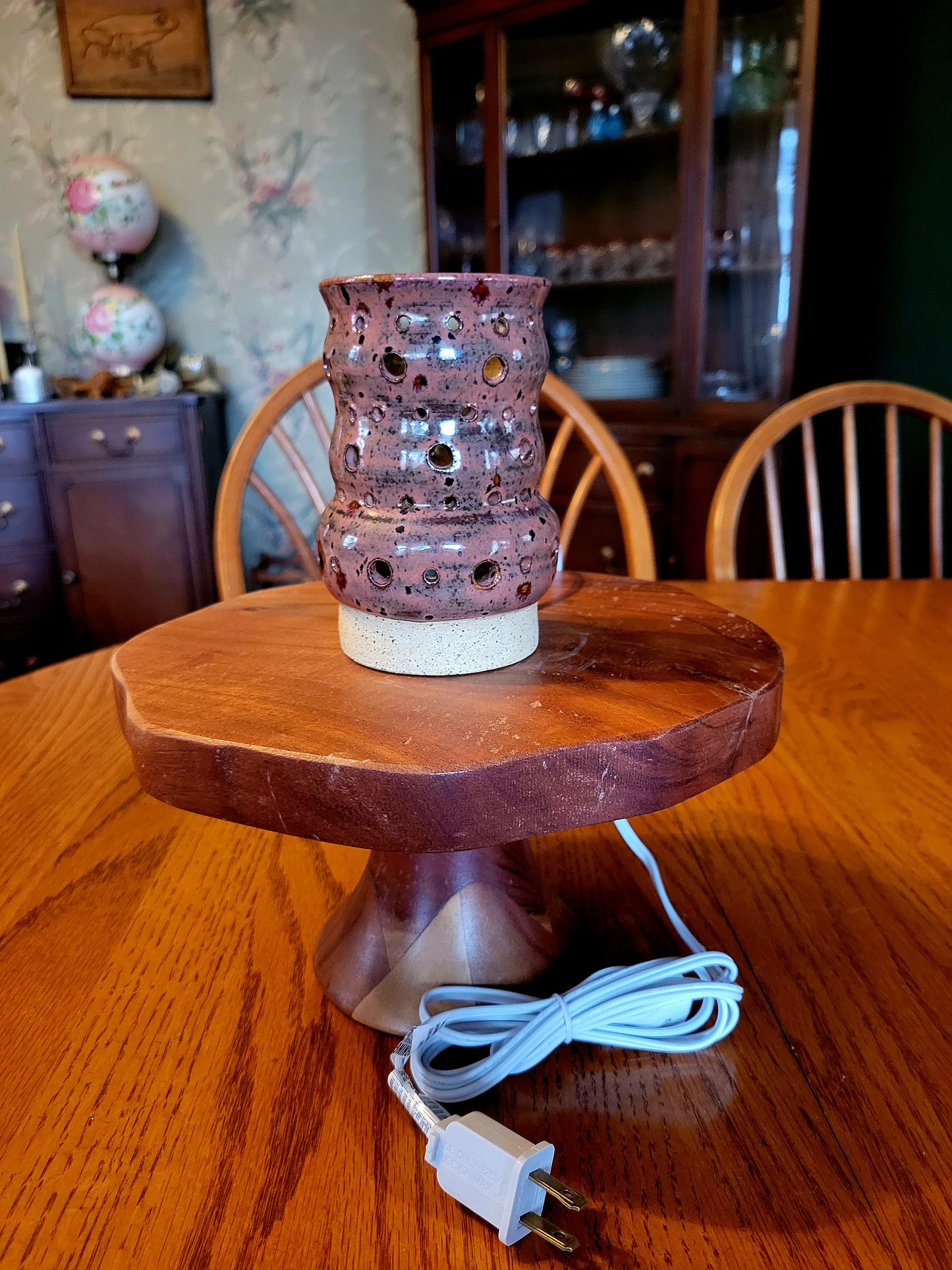 Decorative lamp on a wooden stand with a blurred background