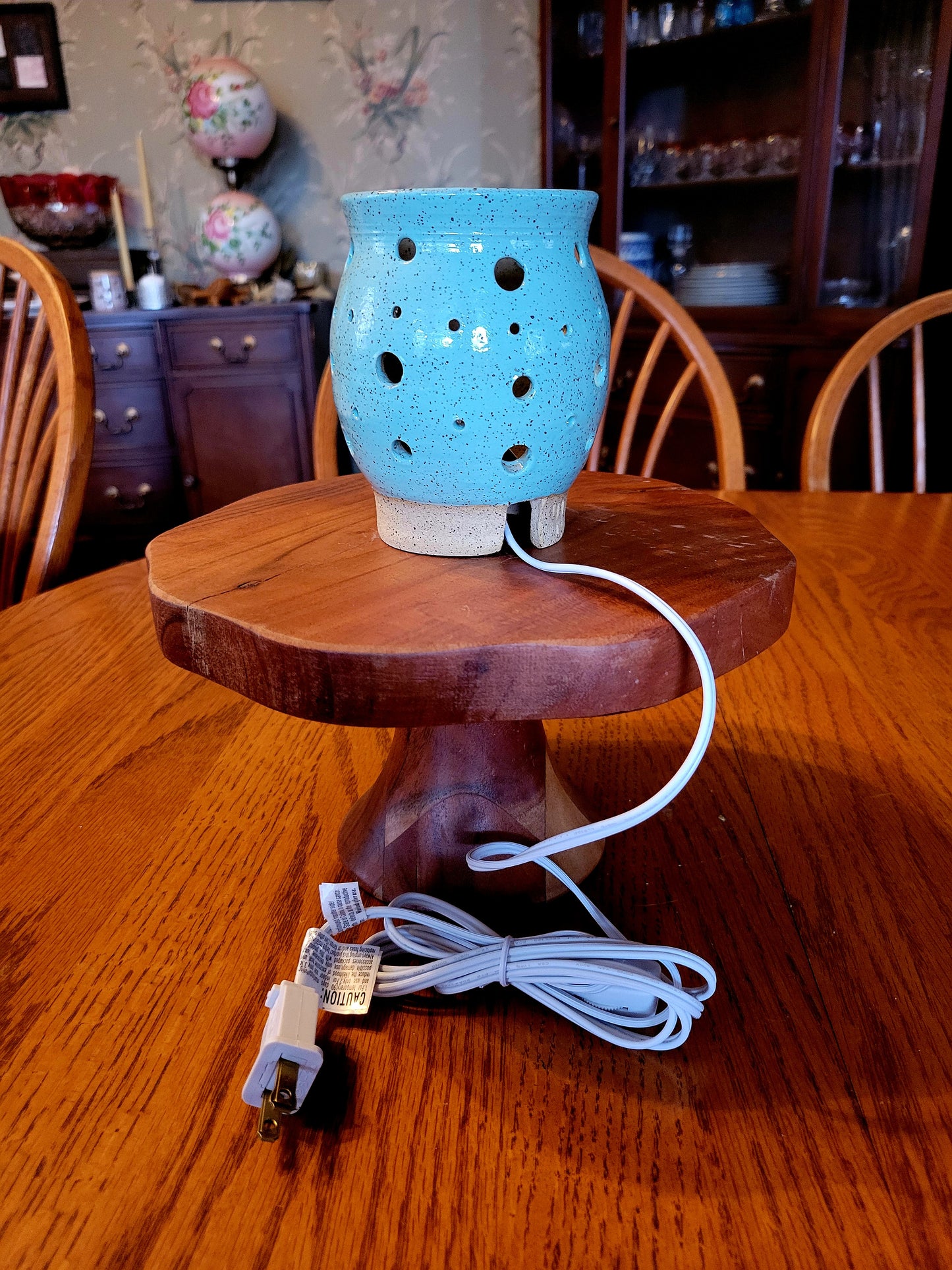 Blue ceramic lamp on a table in a room setting